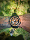 Wooden watch on a wrist with a natural background