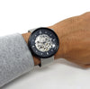 Black watch with silver hardware on a mans wrist